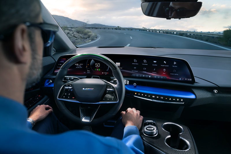 Front View of the 2026 OPTIQ-V Driving Through the Dusk Utilizing its Headlights | Cummins Cadillac in Weatherford OK